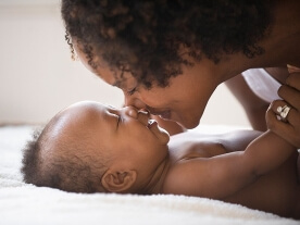 mom kissing her baby