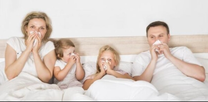 family of 4 in bed with the flu