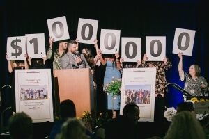 people holding up a $1 million sign