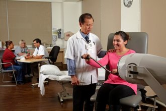 woman doing physical therapy with her doctor