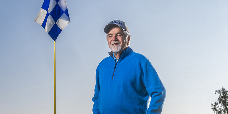 man standing by flag post