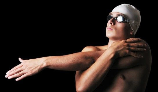 swimmer stretching his shoulder